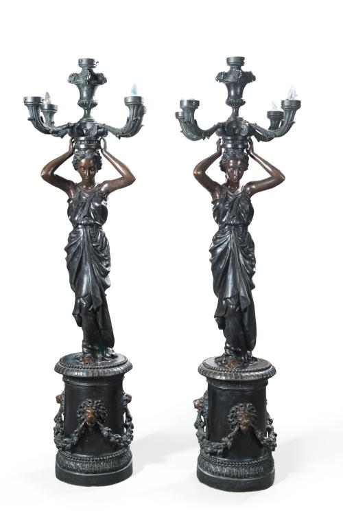 214   -  <p><span class="object_title">Pareja de torcheros en bronce pavonado con fuste de damas clásicas sosteniendo una pareja de candelabros de cinco luces. C. 1900. <br/></span><br></p>