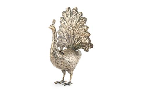 Pavo real en metal plateado con alas articuladas. 