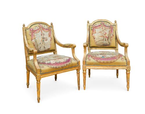 238   -  <p><span class="object_title">Pareja de sillones estilo Luis XVI, Francia, s. XIX<br/>En madera tallada y dorada, patas troncocónicas acanaladas, respaldo en"anse de panier".<br/>Tapicería Aubusson en respaldo con escena pastoral entre cortinajes y guirnaldas de flores, y en asiento gran medallón central orlado por motivos florales. </span><br></p>